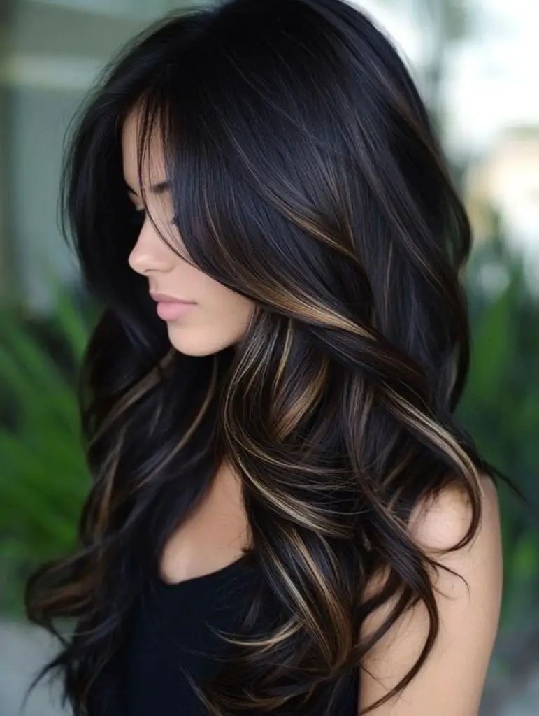 Long brunette hair with soft layers and dimensional highlights.