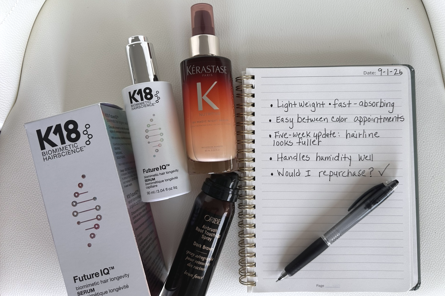 K18, Oribe, and Kérastase hair products beside handwritten Studio testing notes.